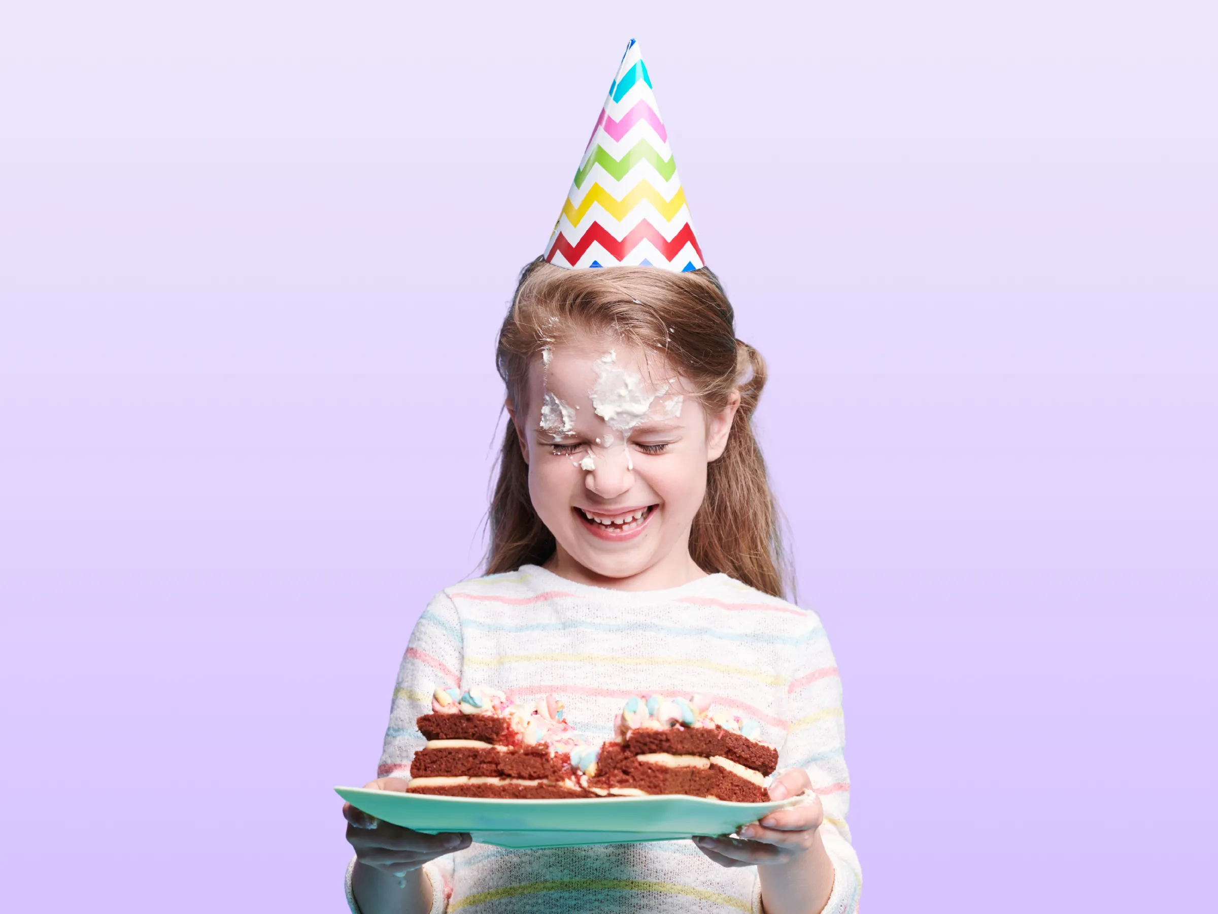 Boy about to blow out a number-nine candle on a chocolate birthday cake