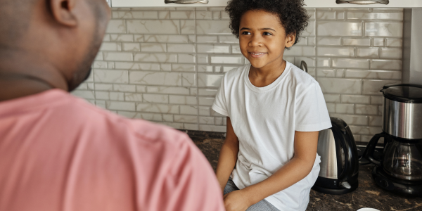 Dad and son chatting in the kitchen