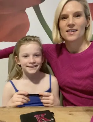 Mum and daughter holding a Spriggy card
