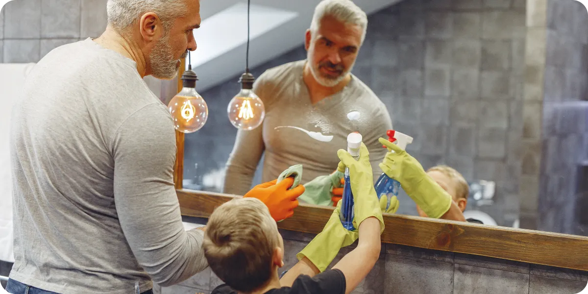 Dad and son cleaning a bathroom together